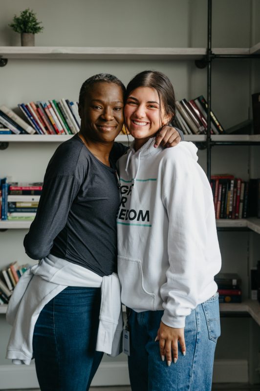 Two women smiling and hugging